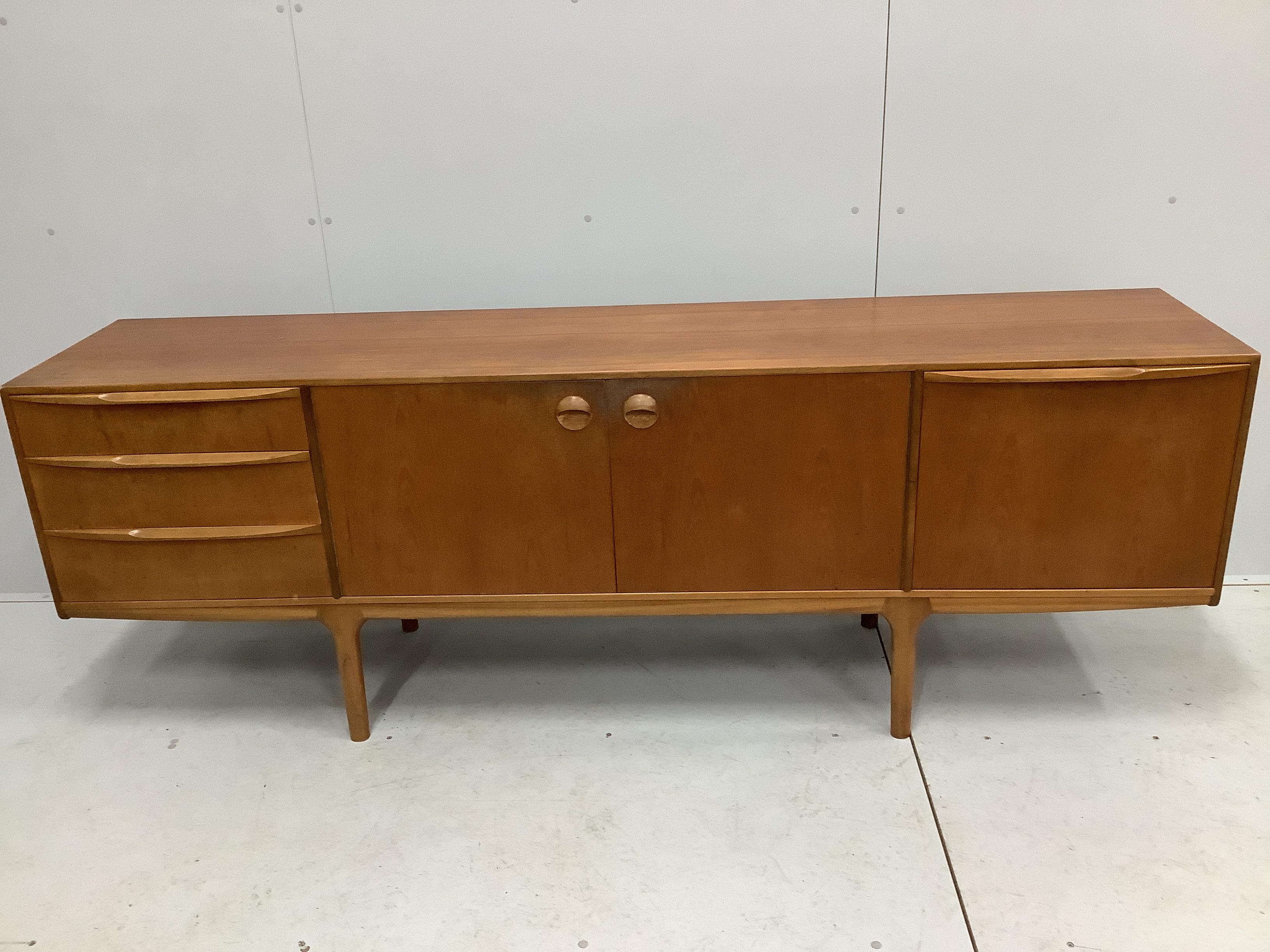 McIntosh of Kirkcaldy, a mid century teak dining suite comprising sideboard, width 213cm, depth 47cm, height 75cm, extending dining table and four chairs